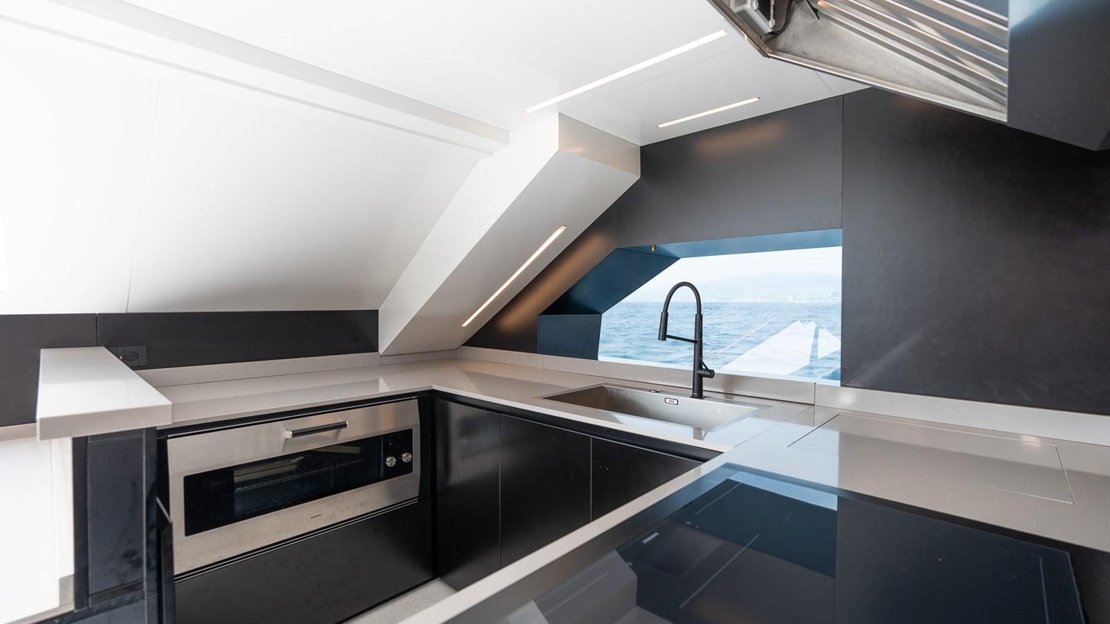 a kitchen with a large window aboard LASTOCHKA Yacht for Sale