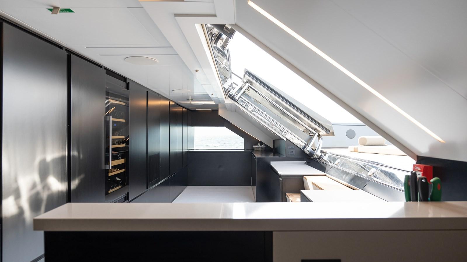 a large black cabinet with a ladder aboard LASTOCHKA Yacht for Sale