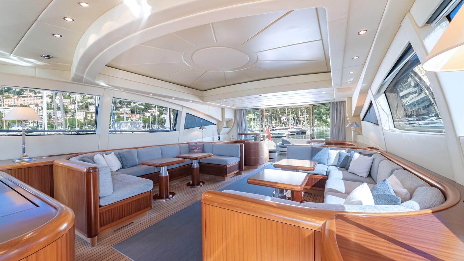 a large living room with a large open window aboard POPEYE Yacht for Sale