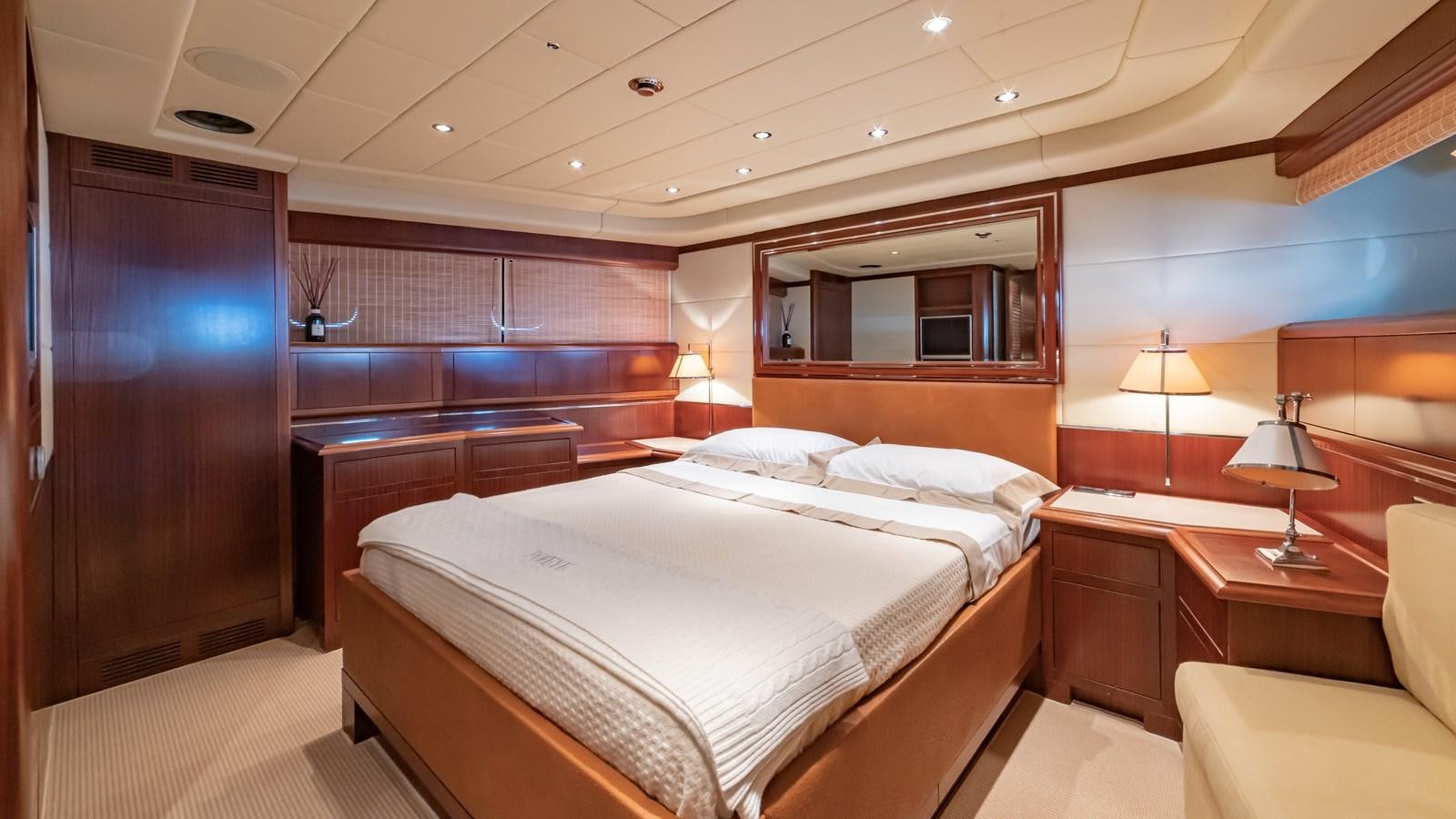 a room with a bed and a television aboard POPEYE Yacht for Sale
