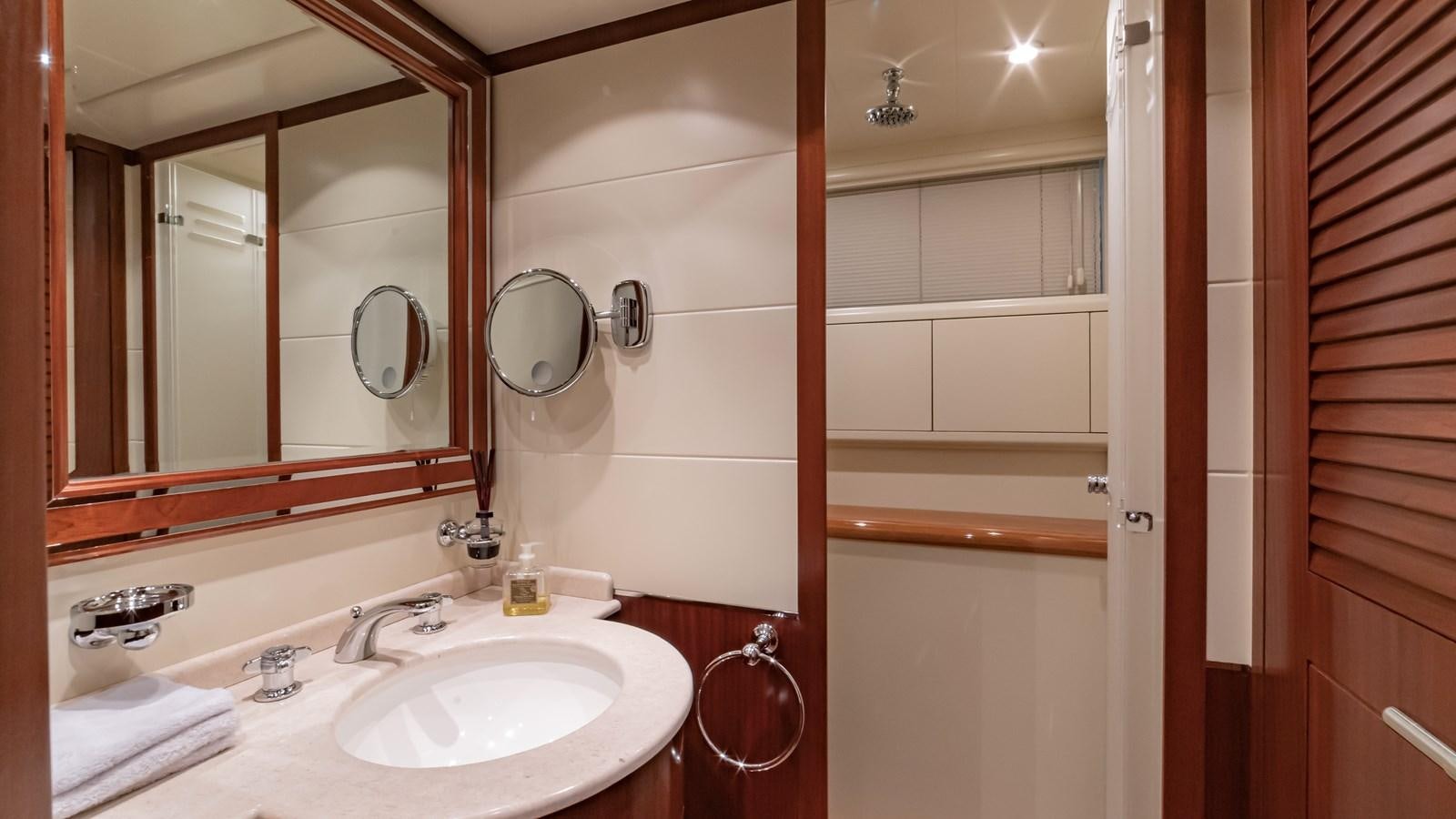 a bathroom with a sink and mirror aboard POPEYE Yacht for Sale