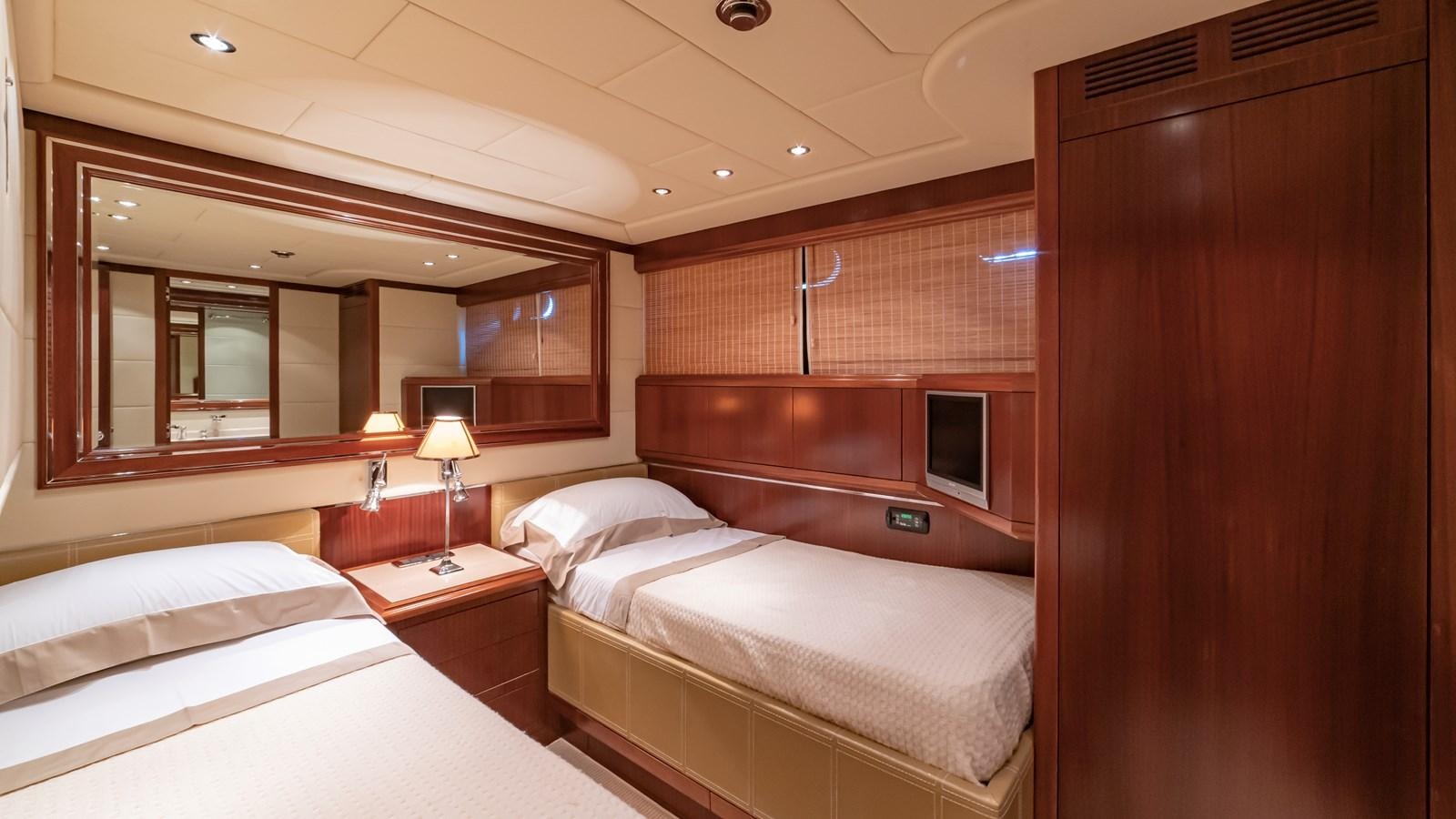 a room with a bed and a mirror aboard POPEYE Yacht for Sale