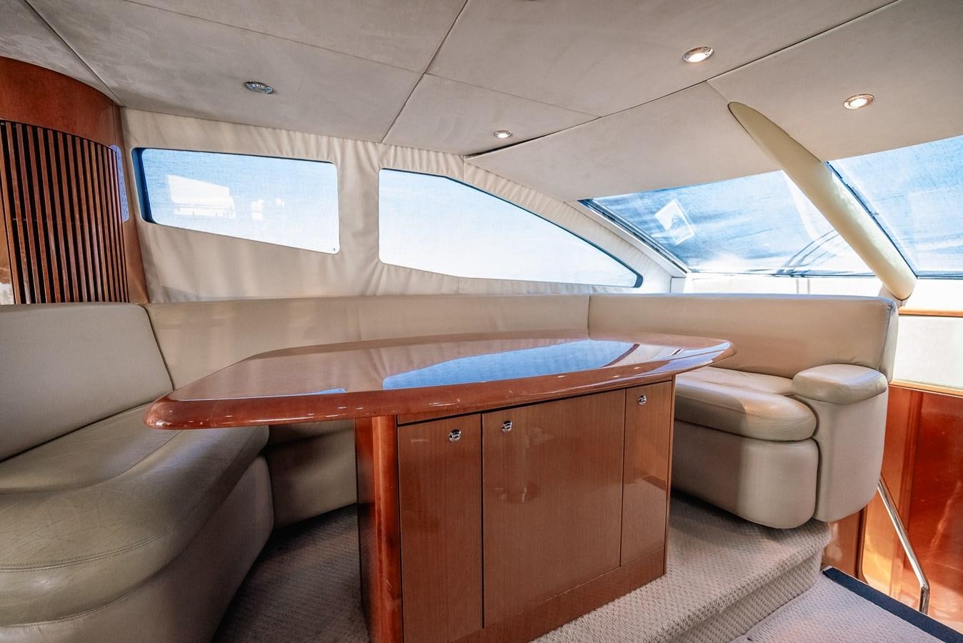 a room with a table and chairs aboard BAR.CO Yacht for Sale