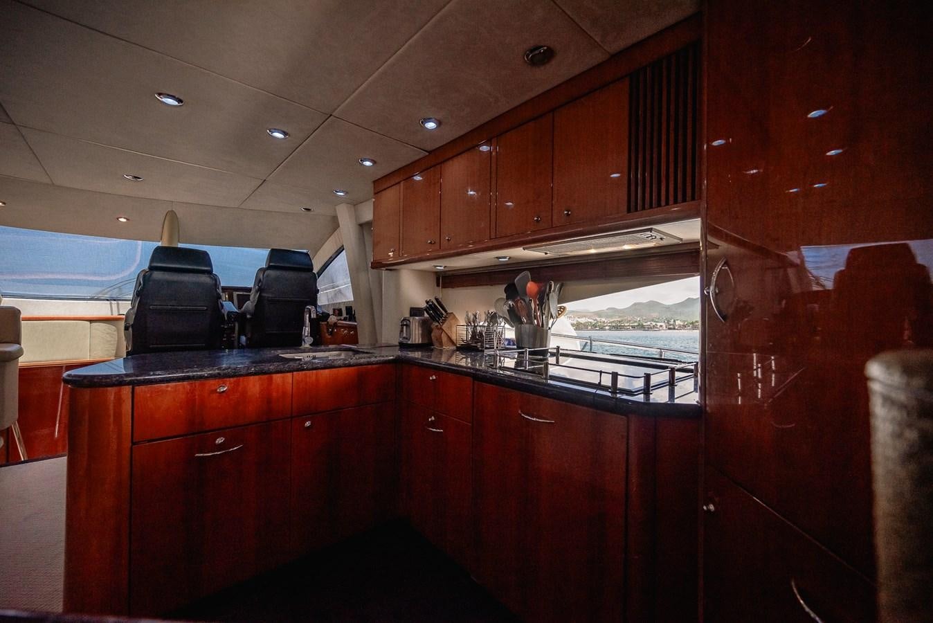 a kitchen with wooden cabinets aboard BAR.CO Yacht for Sale