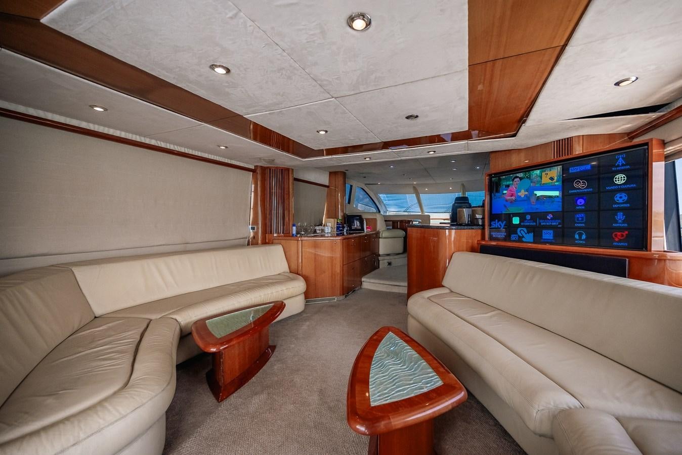 a room with a couch and a tv on the wall aboard BAR.CO Yacht for Sale