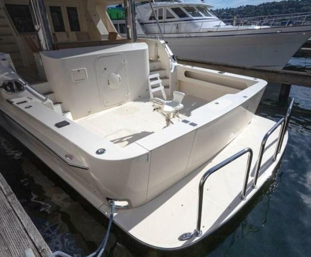 a white boat on a dock aboard AL DI LA Yacht for Sale