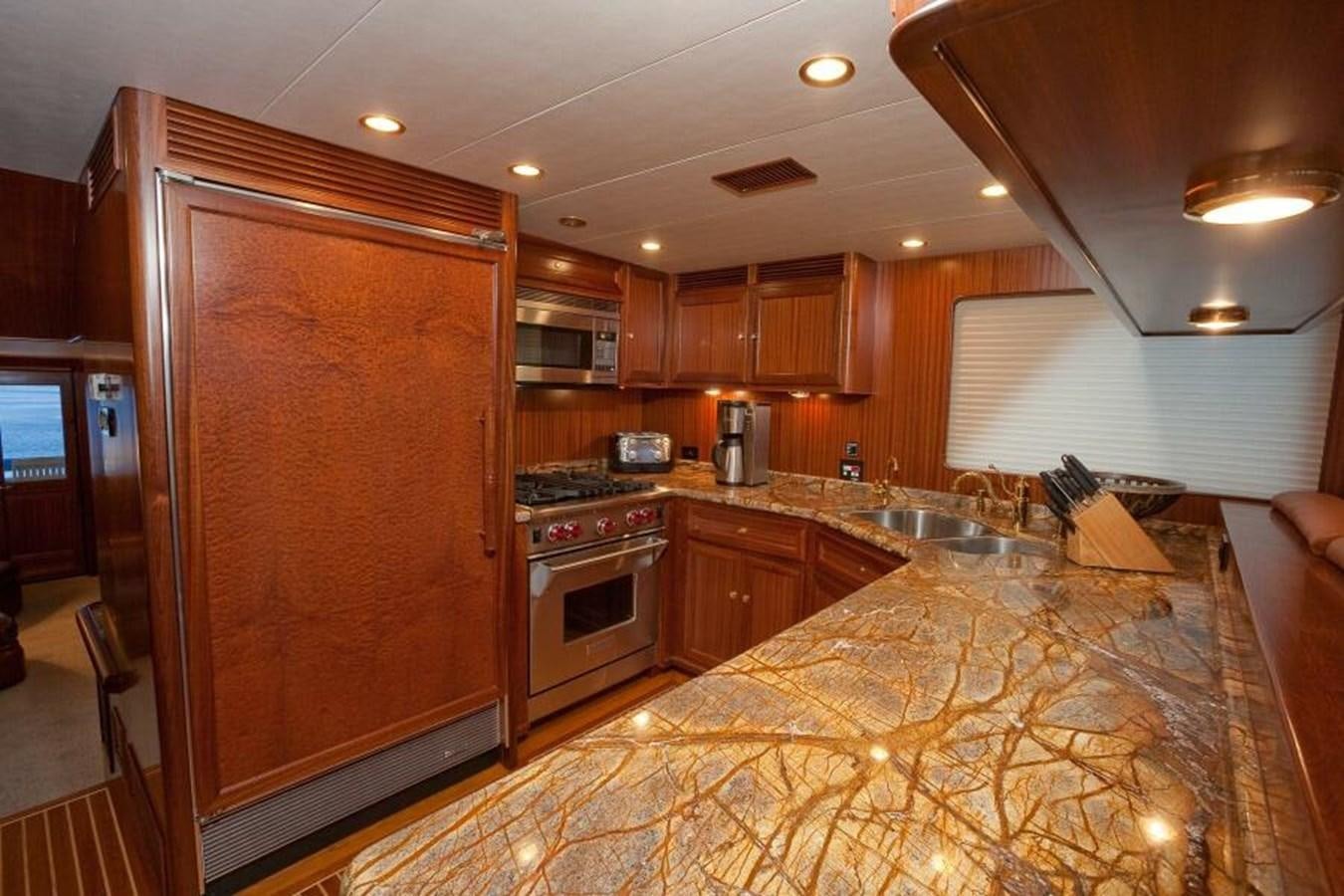 a kitchen with wooden cabinets aboard AL DI LA Yacht for Sale