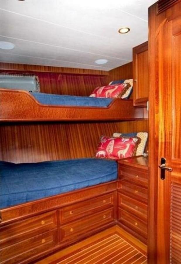 a bed with a blue sheet aboard AL DI LA Yacht for Sale