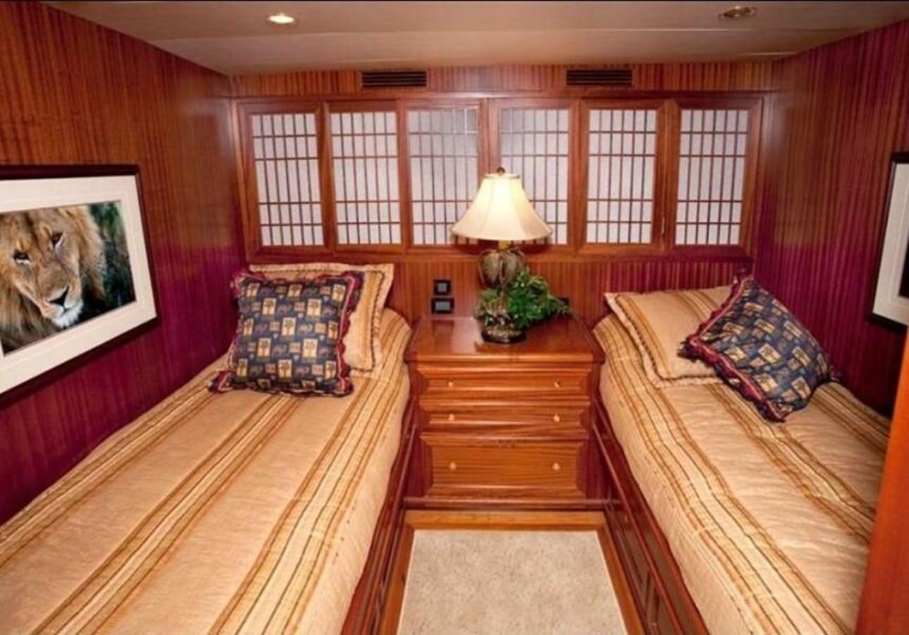 a bedroom with a bed and a lamp on the table aboard AL DI LA Yacht for Sale