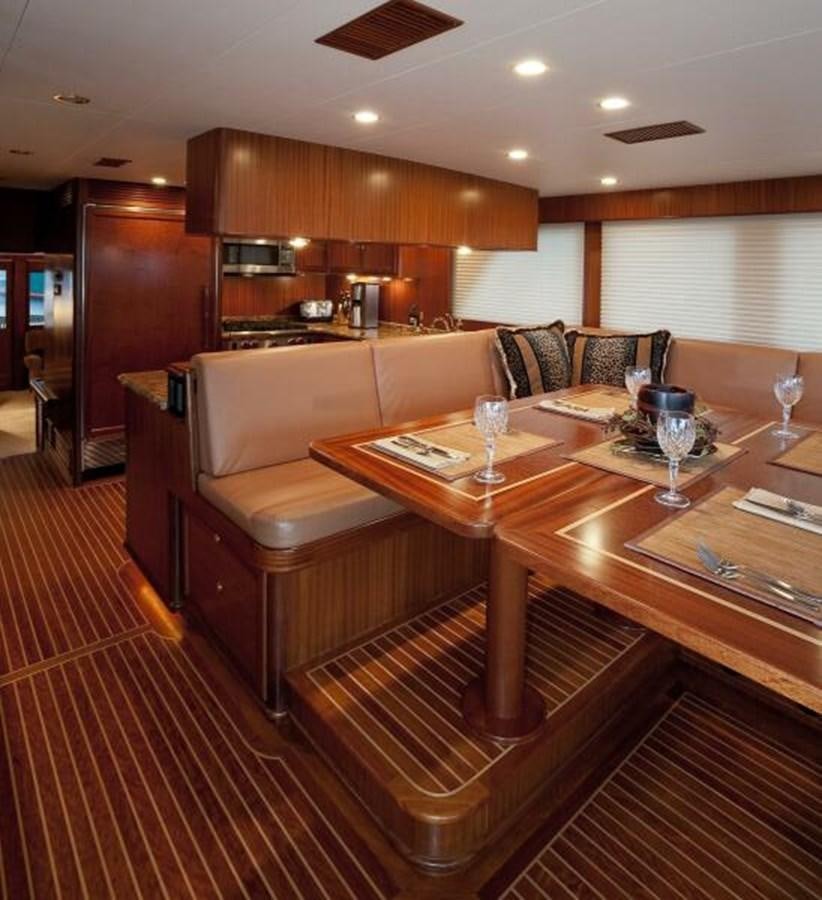 a living room with a table and couches aboard AL DI LA Yacht for Sale