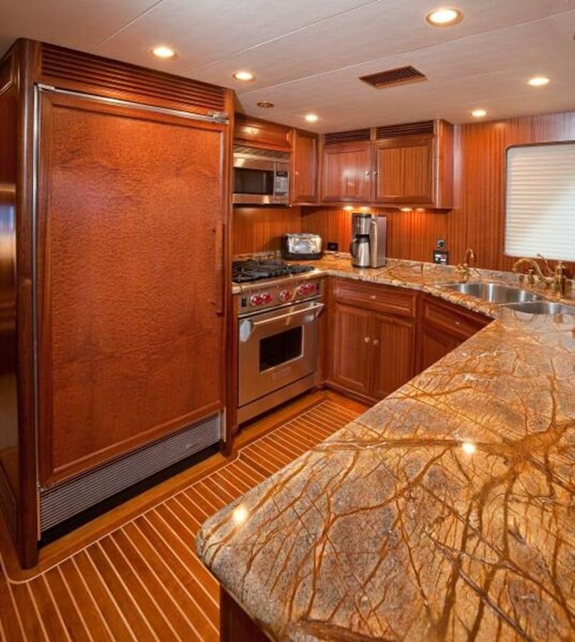 a kitchen with wooden cabinets aboard AL DI LA Yacht for Sale