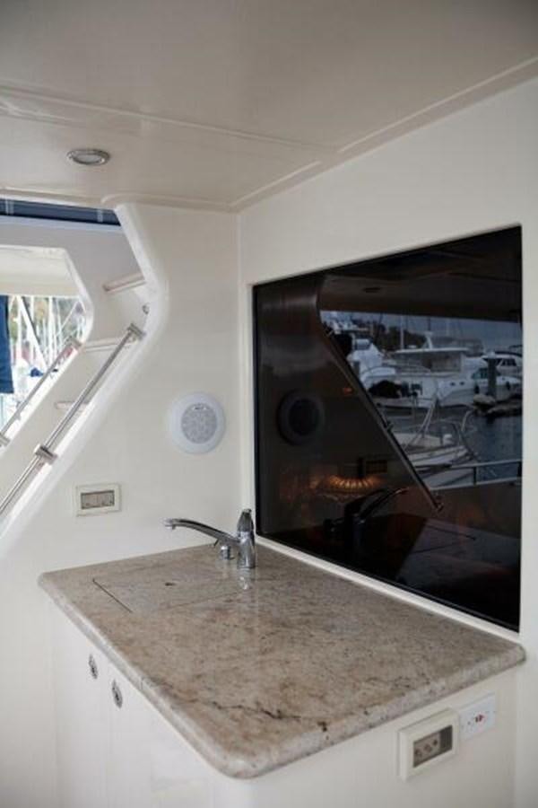 a kitchen counter with a large television aboard AL DI LA Yacht for Sale
