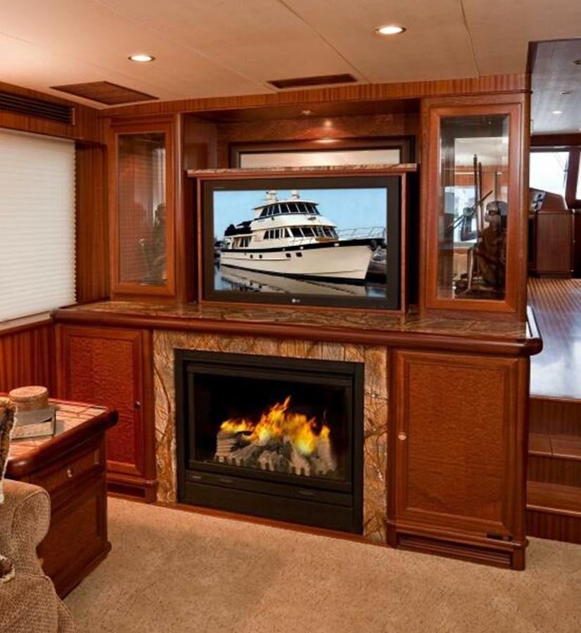 a fireplace with a television on aboard AL DI LA Yacht for Sale