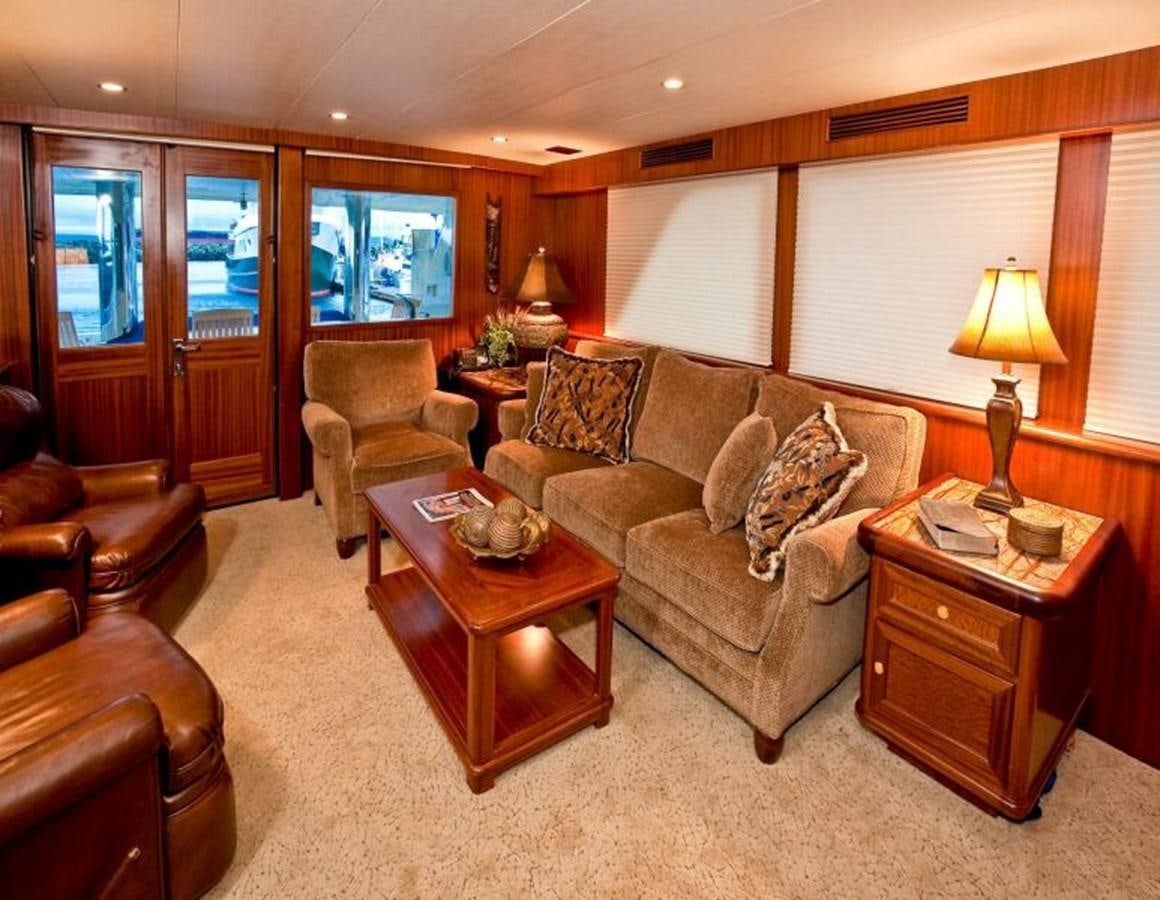 a living room with a leather couch and a wood coffee table aboard AL DI LA Yacht for Sale