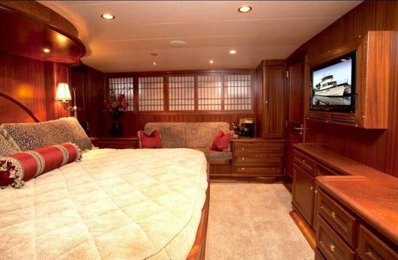 a bedroom with a bed and a tv aboard AL DI LA Yacht for Sale