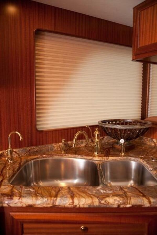 a kitchen with a sink and a large window aboard AL DI LA Yacht for Sale