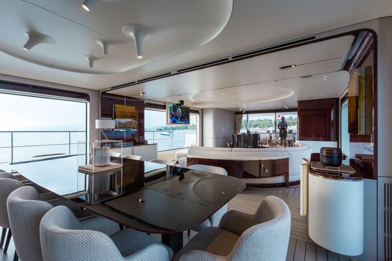 a room with a table chairs and a window aboard 2019 AZIMUT GRANDE 35 M/Y HEED Yacht for Sale