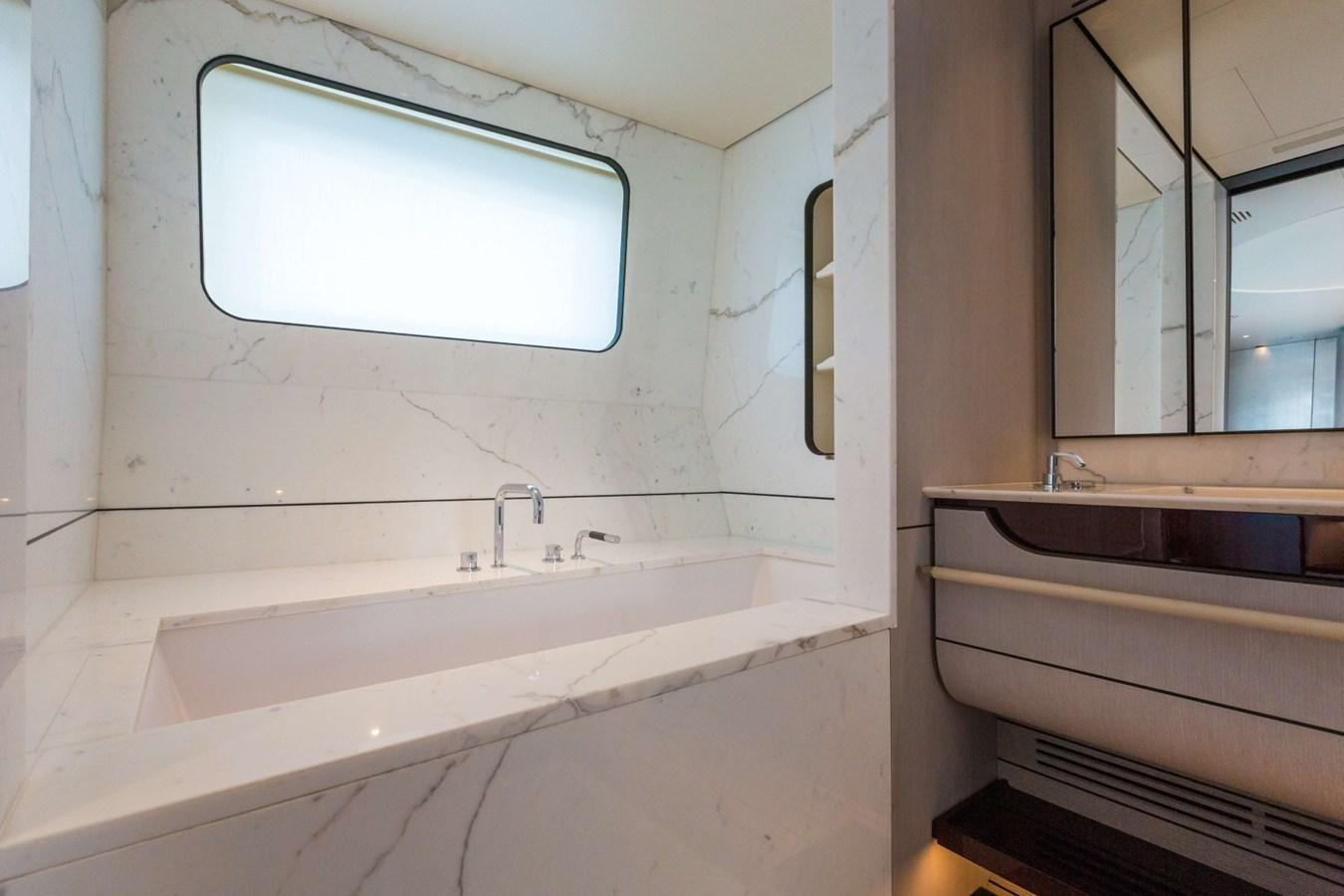 a bathroom with a sink and a window aboard 2019 AZIMUT GRANDE 35 M/Y HEED Yacht for Sale