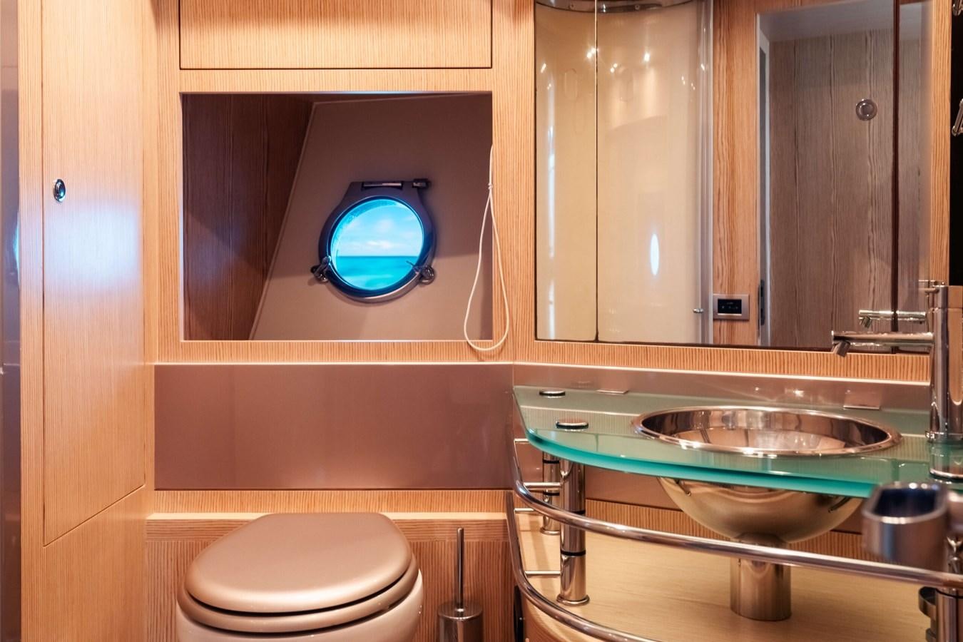 a bathroom with a round mirror aboard 2008 RIVA SUPER EGO 68 Yacht for Sale