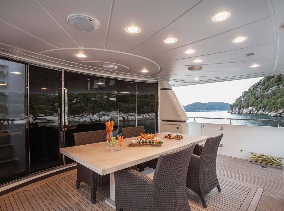 a table with chairs around it aboard 2009 SANLORENZO SL88 #541 Yacht for Sale