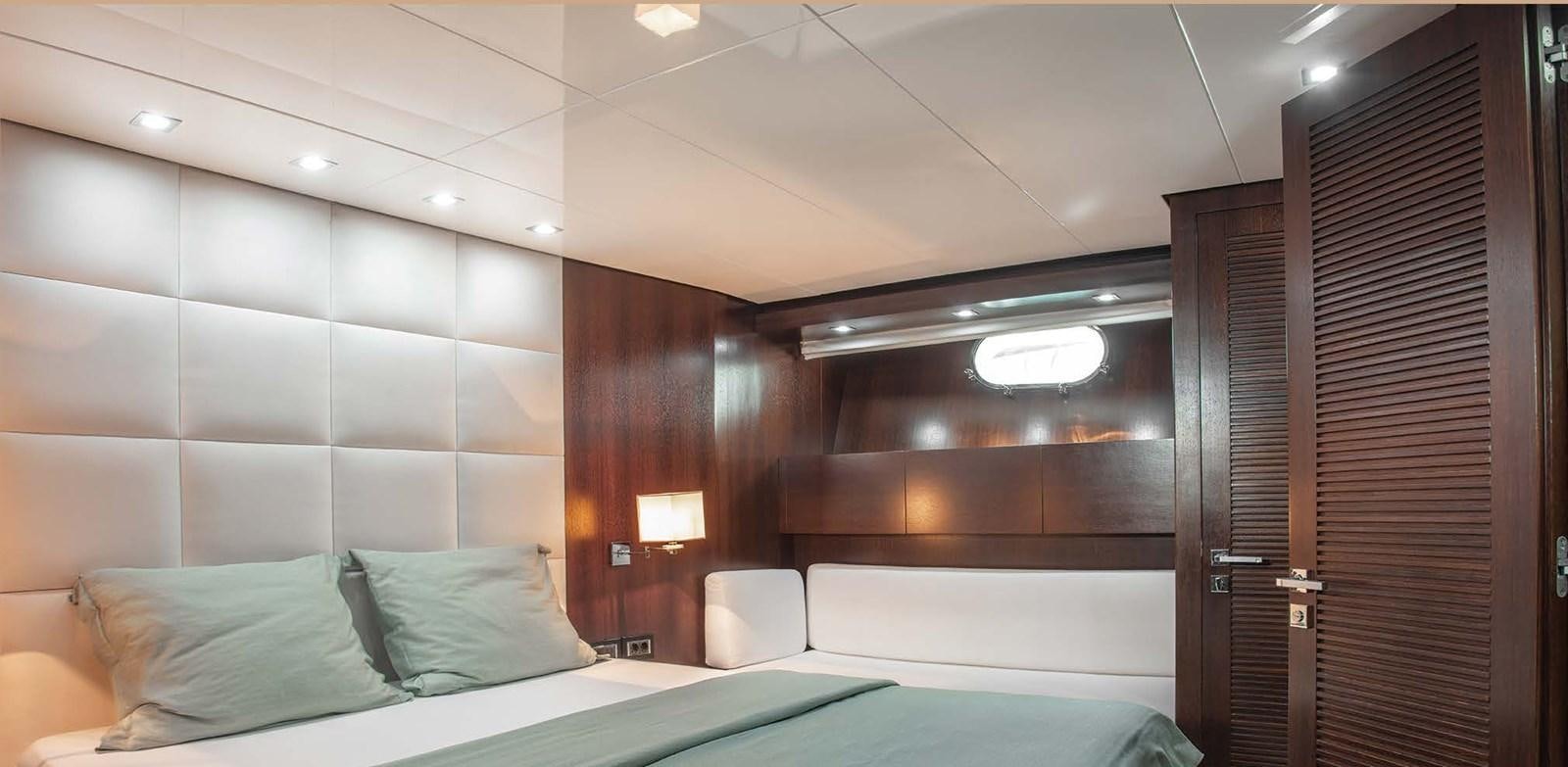 a room with a bed and a desk aboard 2009 SANLORENZO SL88 #541 Yacht for Sale