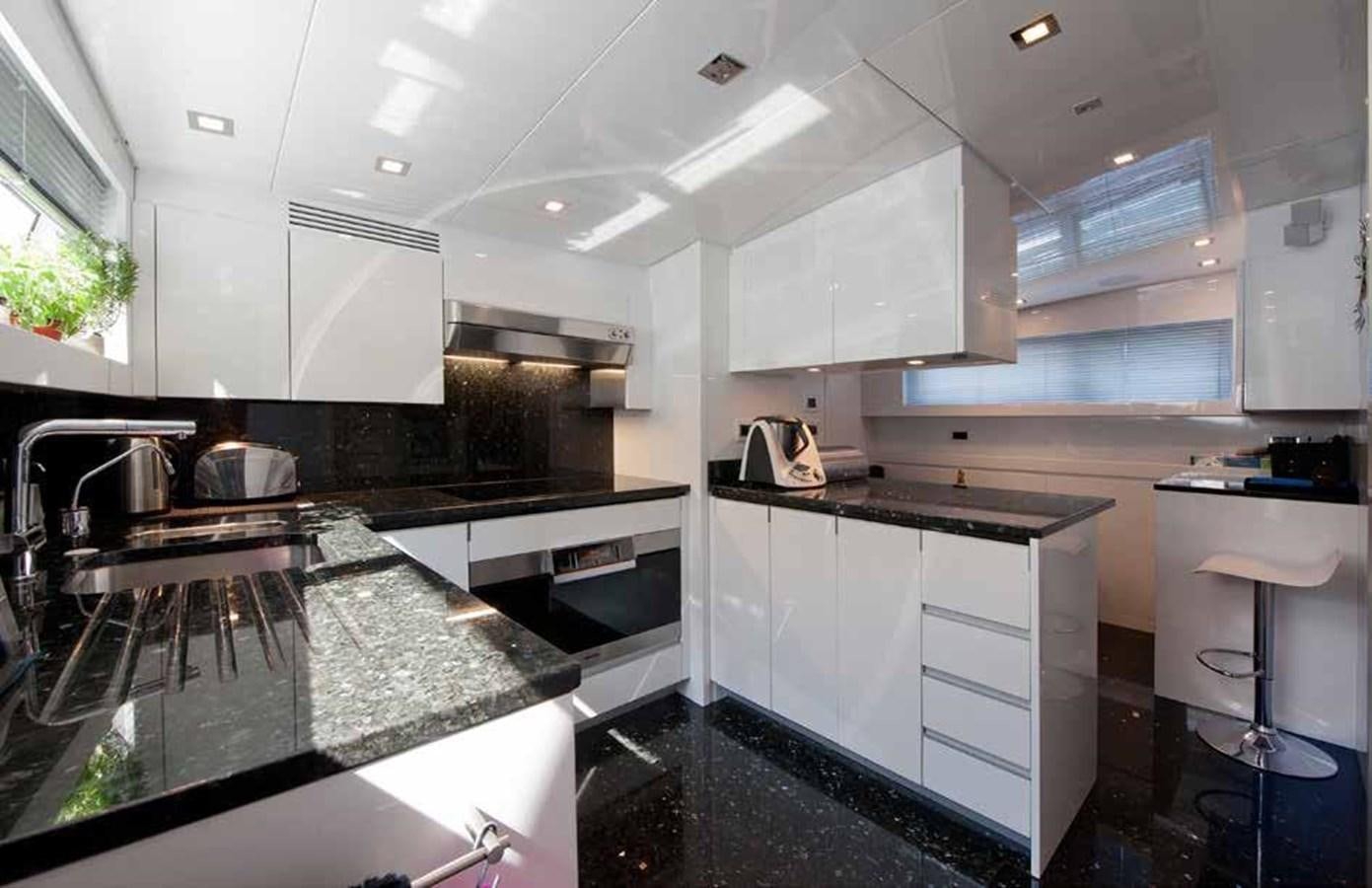 a kitchen with white cabinets aboard 2009 SANLORENZO SL88 #541 Yacht for Sale