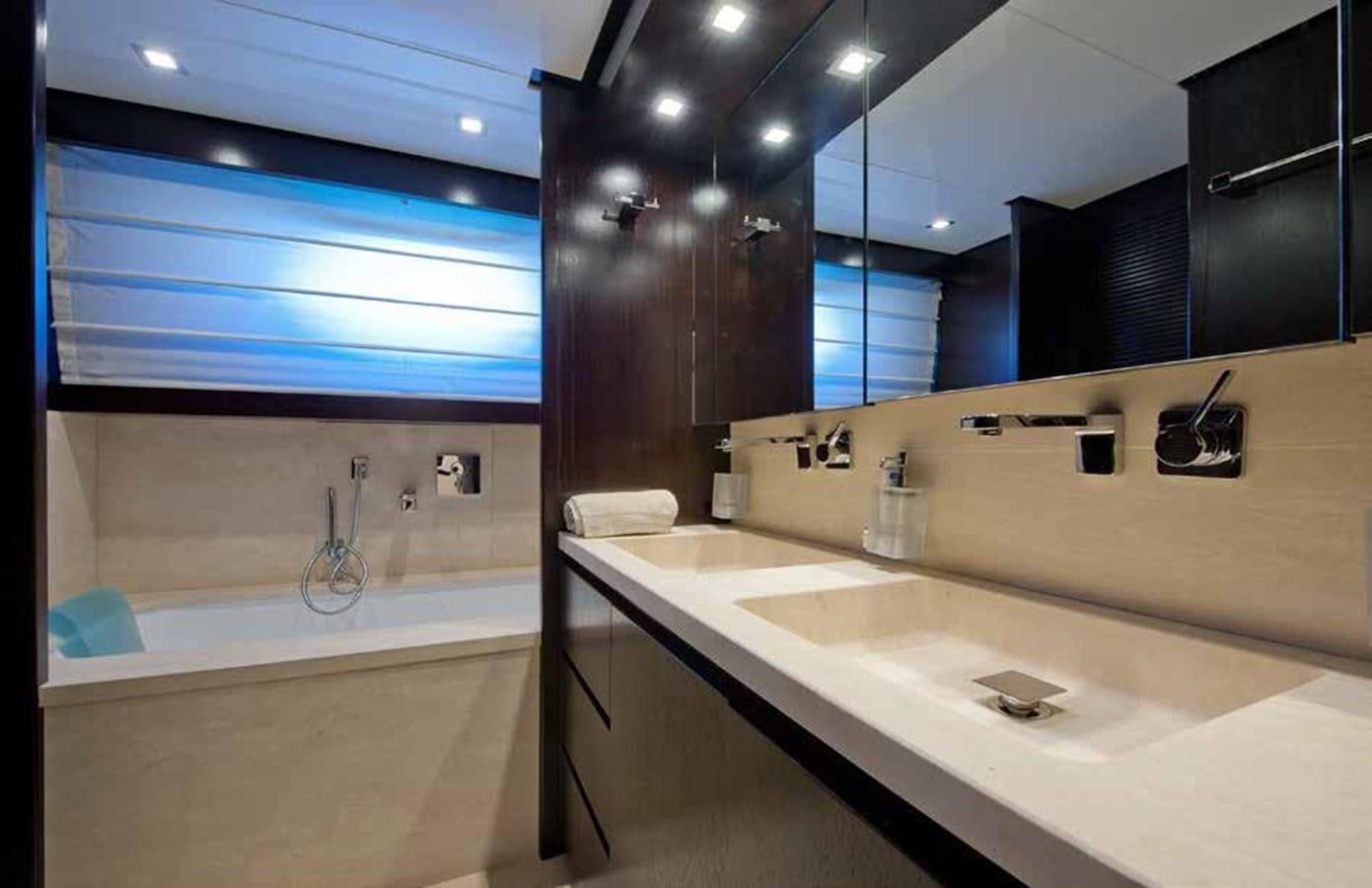 a bathroom with a tub sink and cabinets aboard 2009 SANLORENZO SL88 #541 Yacht for Sale