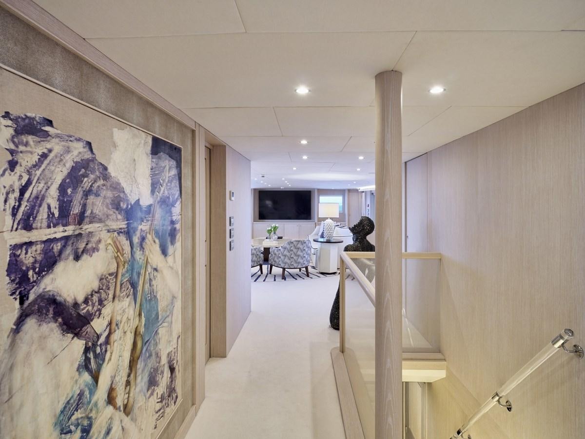 a hallway with a painting on the wall aboard AKULA Yacht for Sale