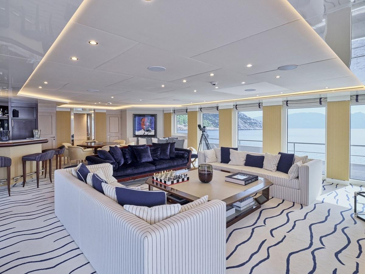 a large living room with a large window aboard AKULA Yacht for Sale
