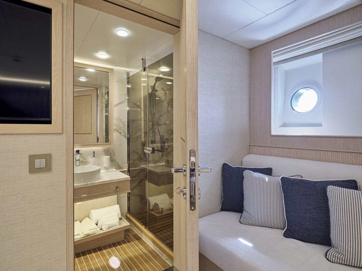 a bathroom with a glass shower aboard AKULA Yacht for Sale