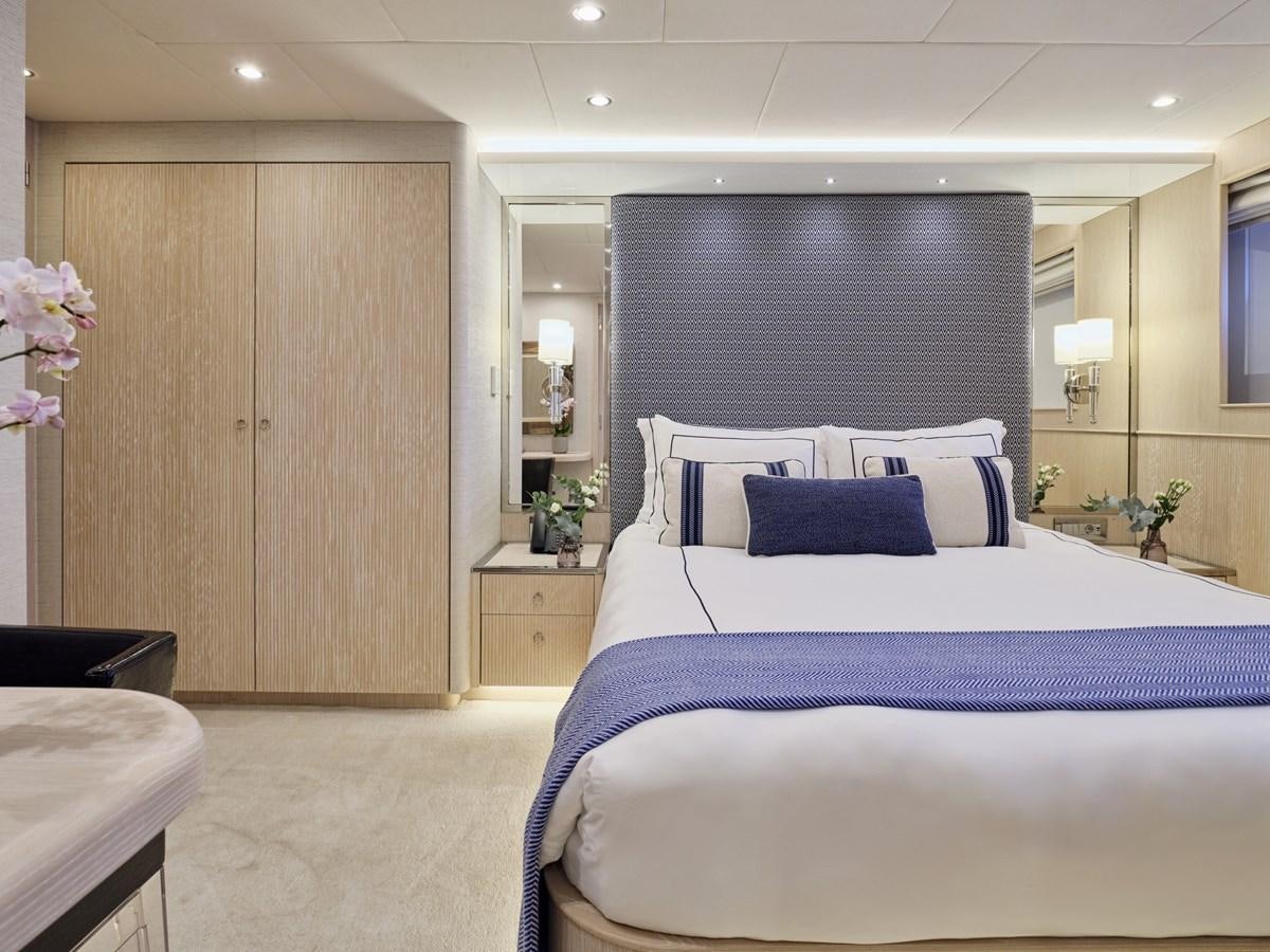 a bedroom with a bed and a desk aboard AKULA Yacht for Sale