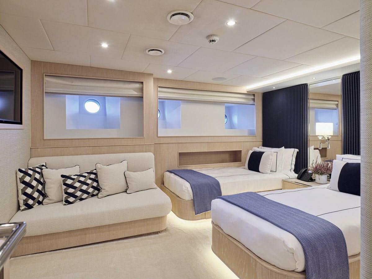 a room with a bed and a couch aboard AKULA Yacht for Sale