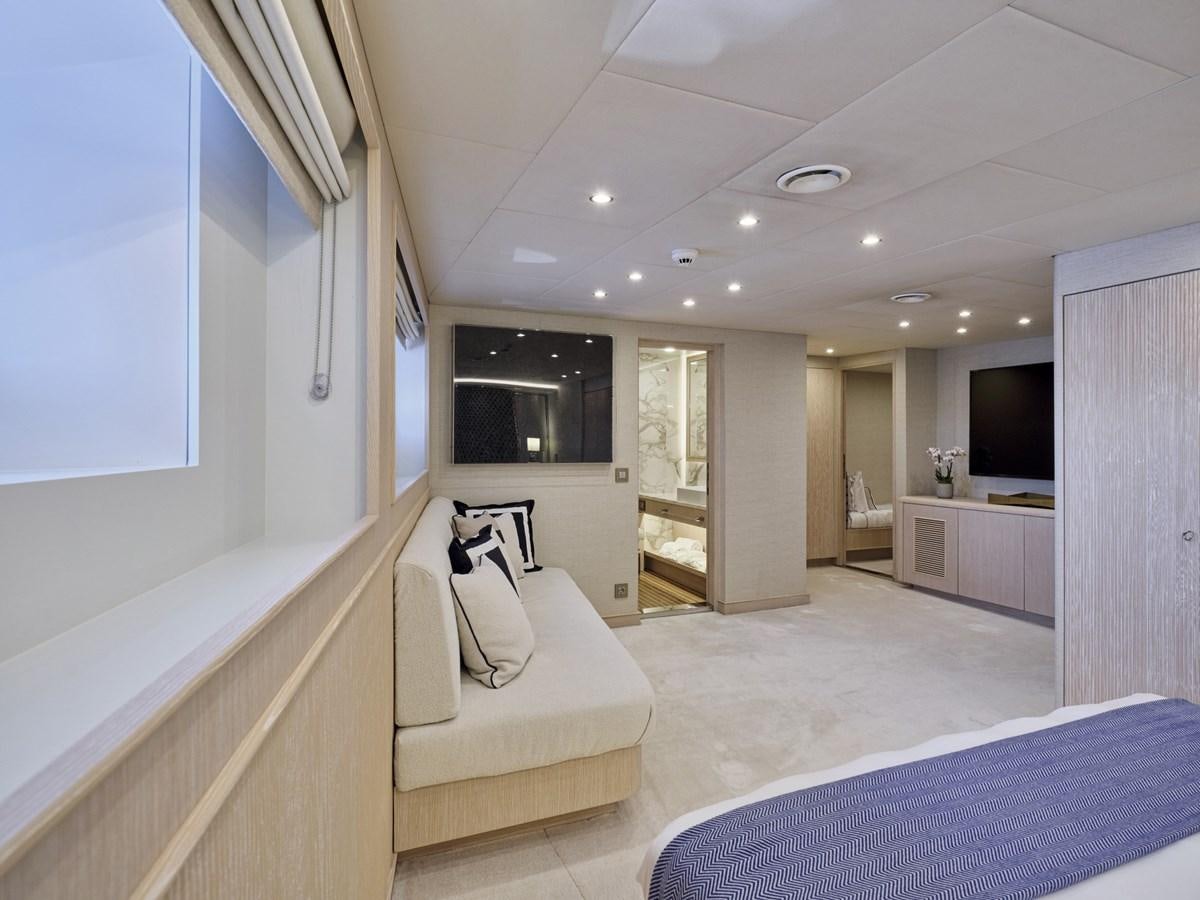 a bedroom with a bed and a tv aboard AKULA Yacht for Sale
