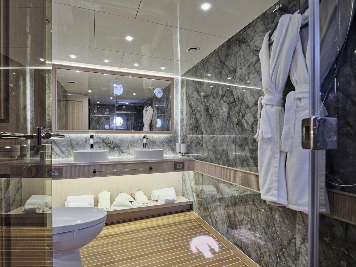 a bathroom with a large mirror aboard AKULA Yacht for Sale