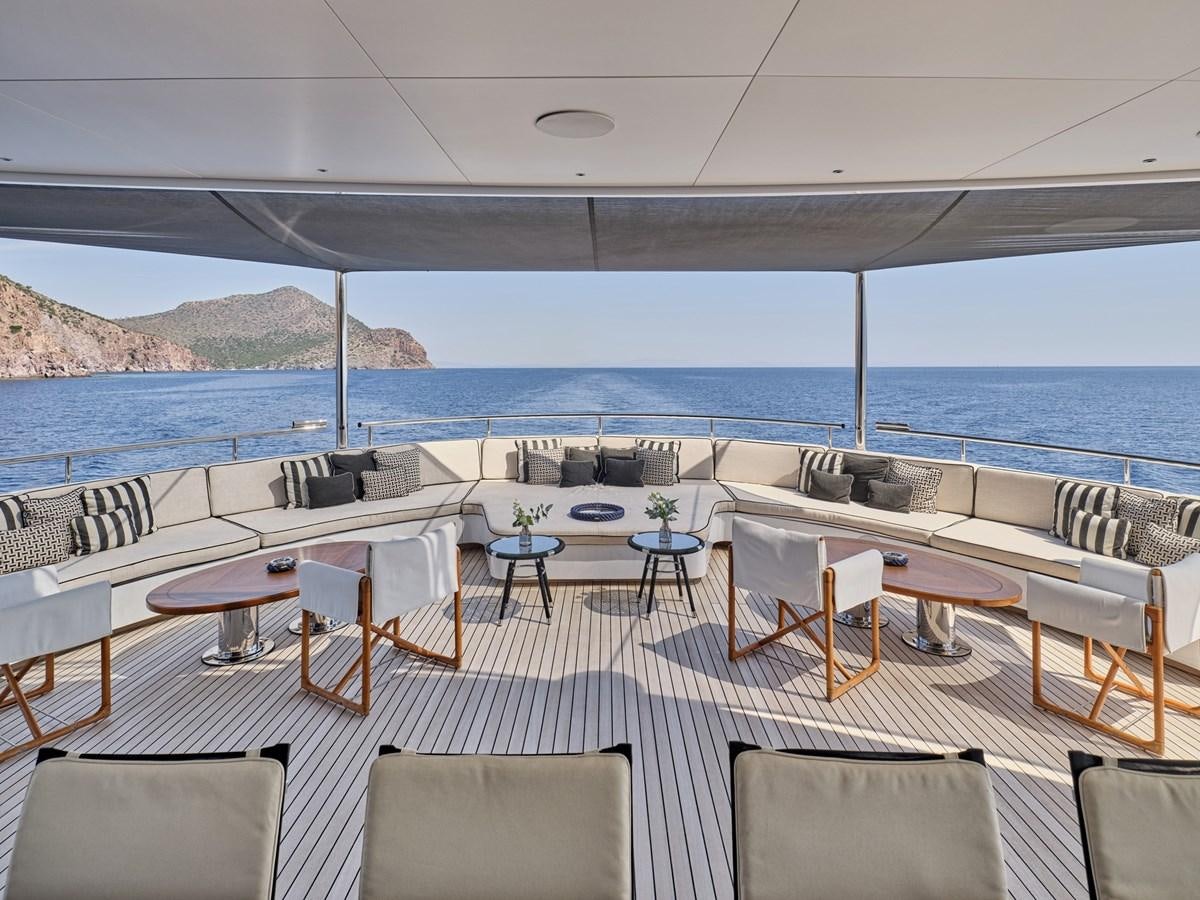 a room with tables and chairs aboard AKULA Yacht for Sale
