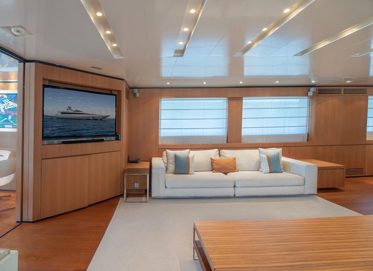 a living room with a large tv aboard TIN TIN Yacht for Sale