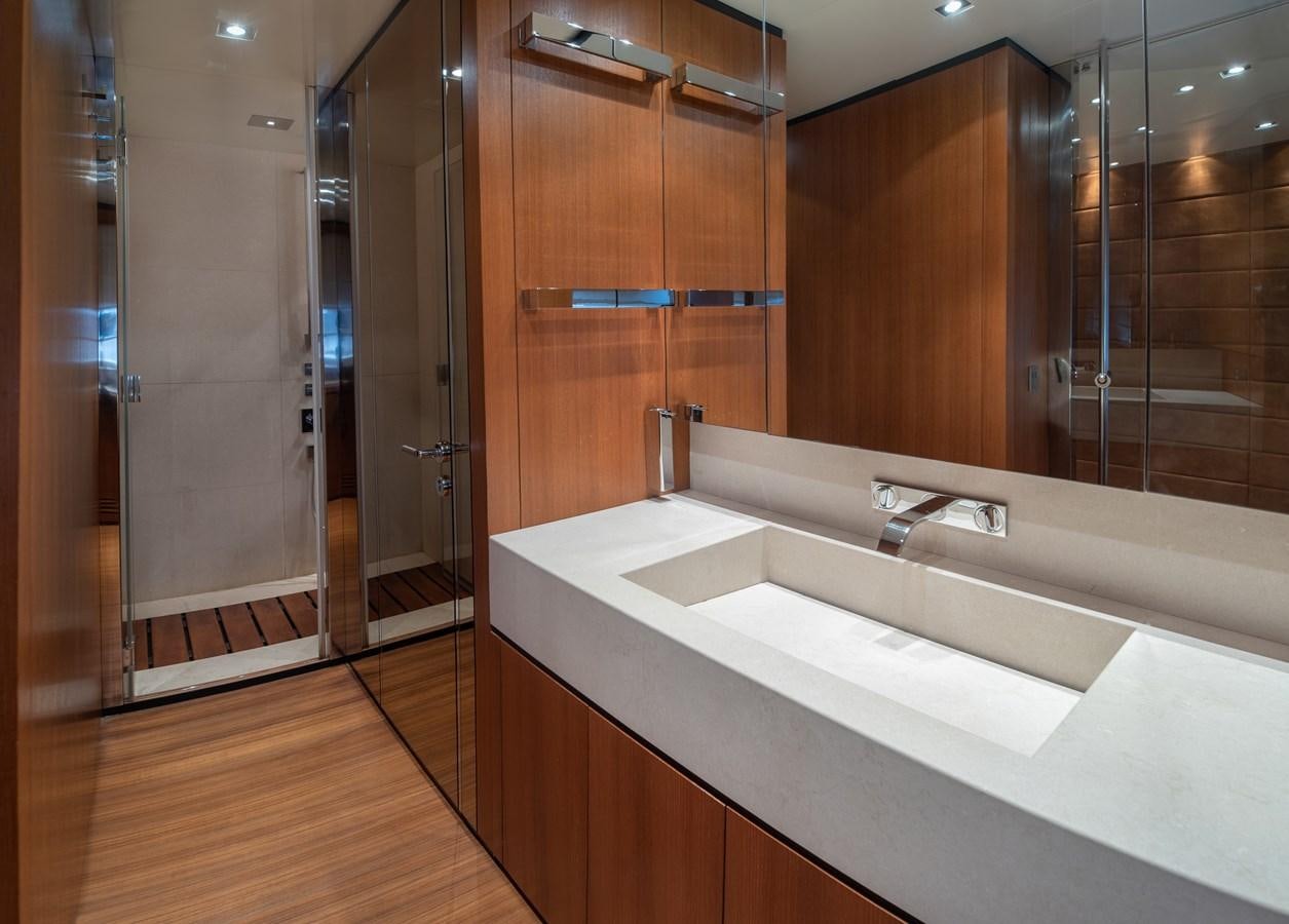 a bathroom with a countertop sink and a shower unit aboard TIN TIN Yacht for Sale
