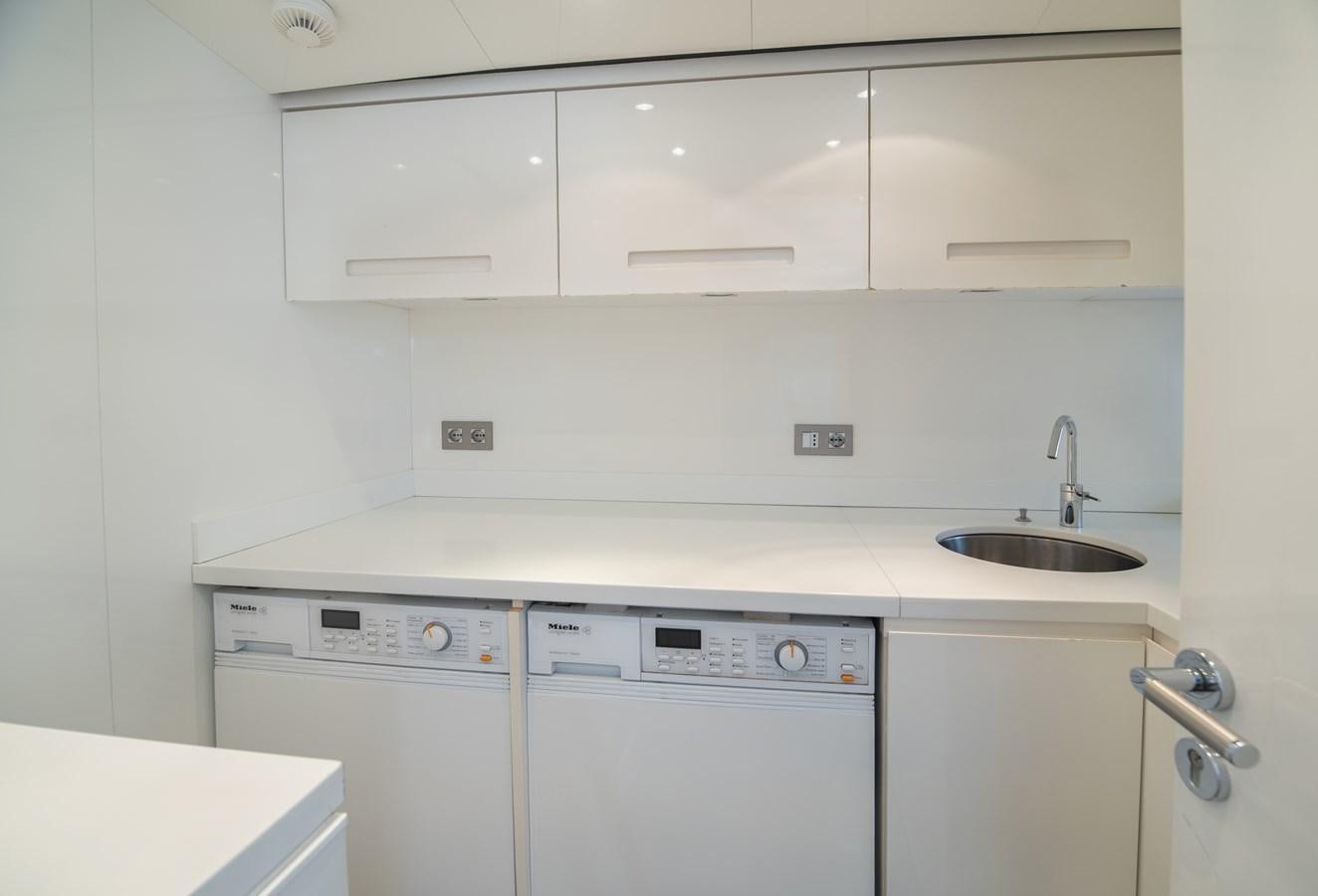 a kitchen with white appliances aboard TIN TIN Yacht for Sale