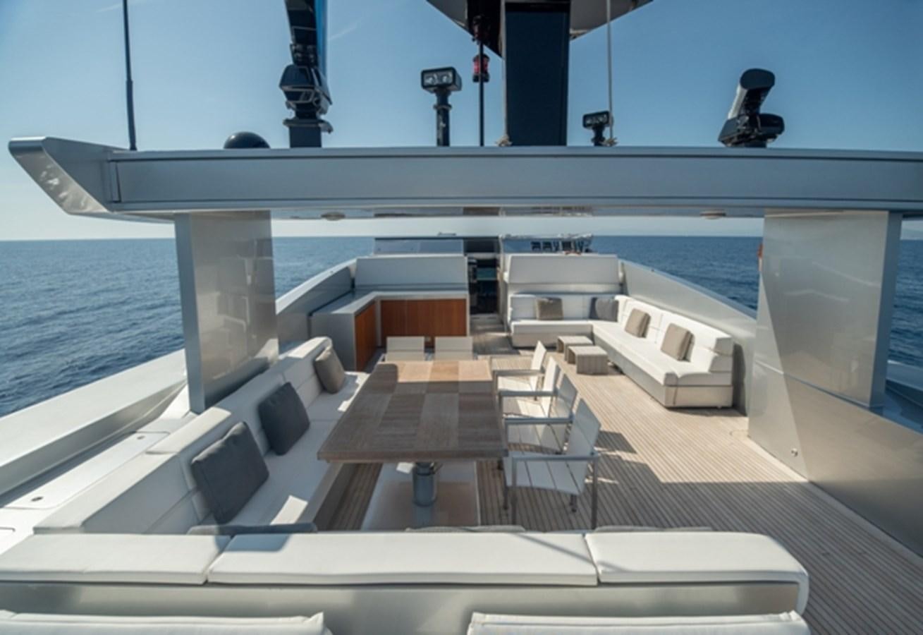 a deck with chairs and a pool aboard TIN TIN Yacht for Sale