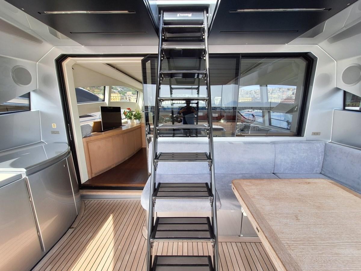 a room with a staircase and a table aboard MYLO Yacht for Sale