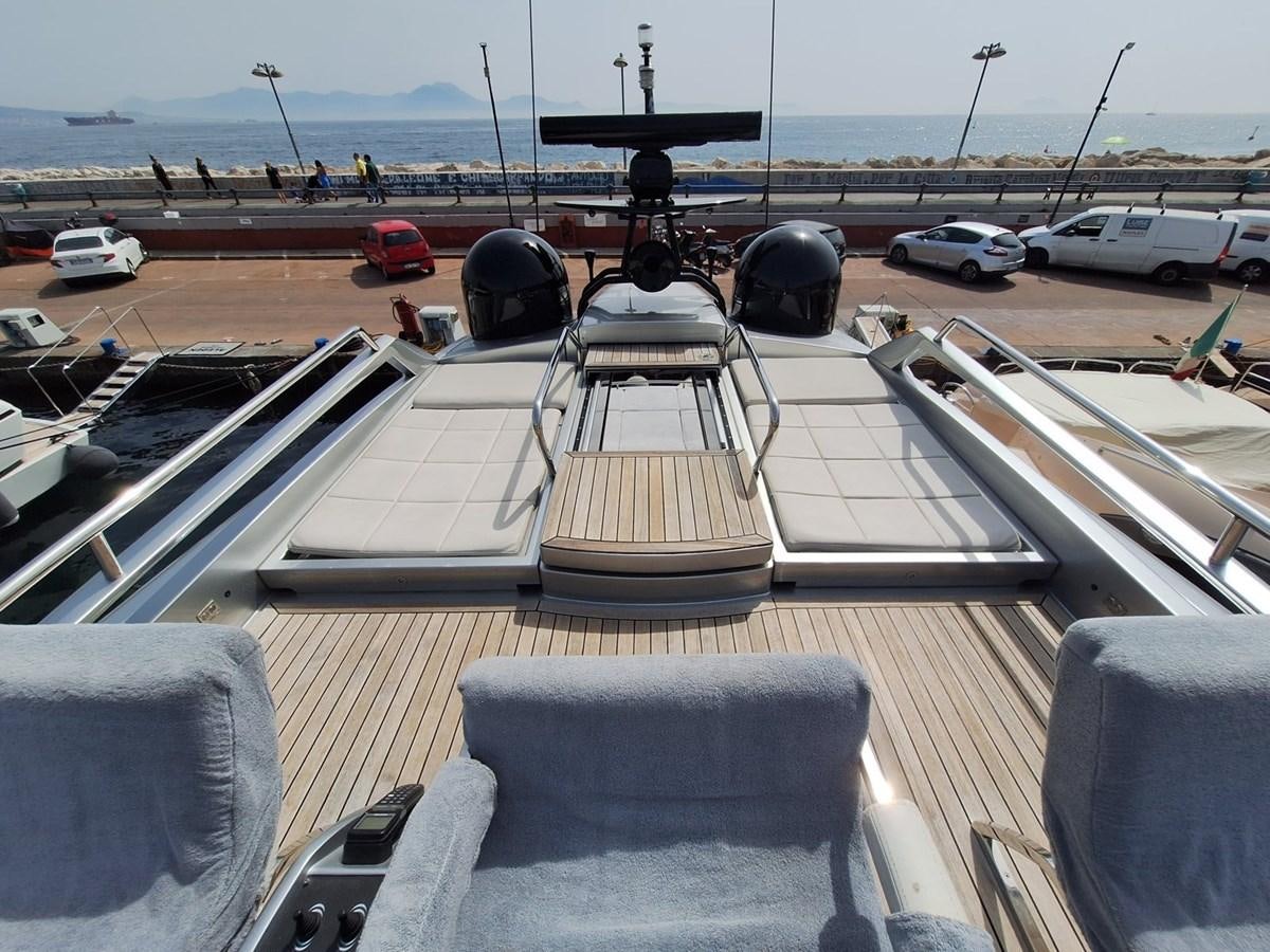 a deck with a grill and cars parked on it aboard MYLO Yacht for Sale