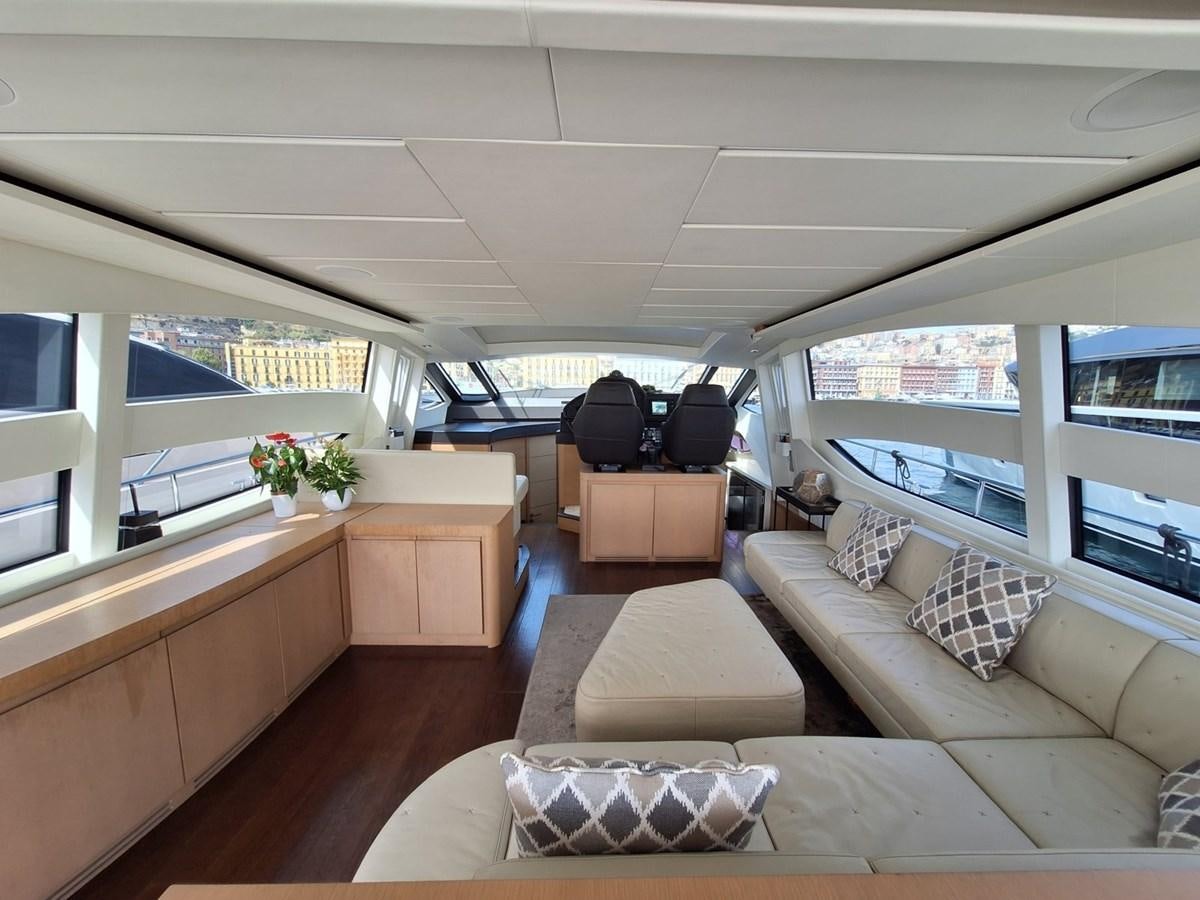a living room with a couch and a large window aboard MYLO Yacht for Sale