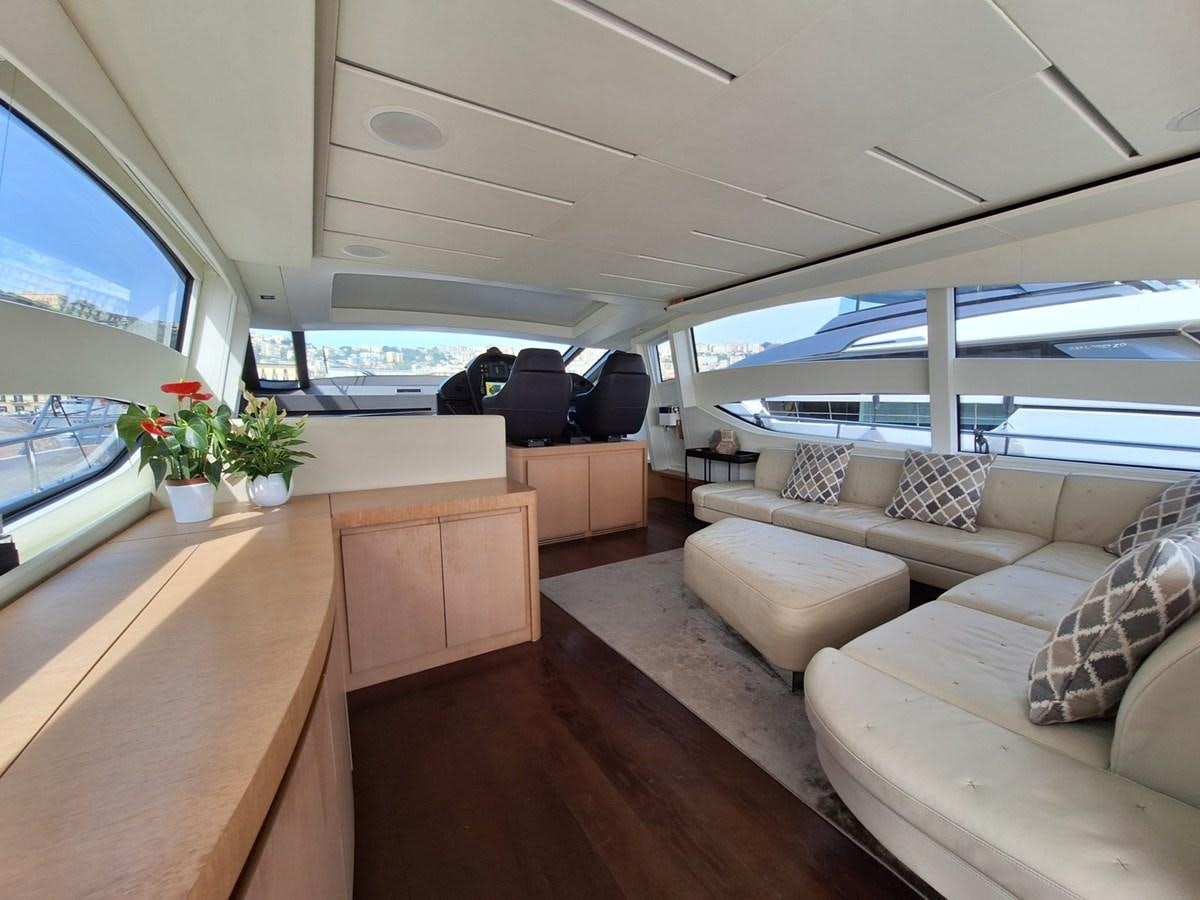 a room with a couch and a table and a view of the water aboard MYLO Yacht for Sale
