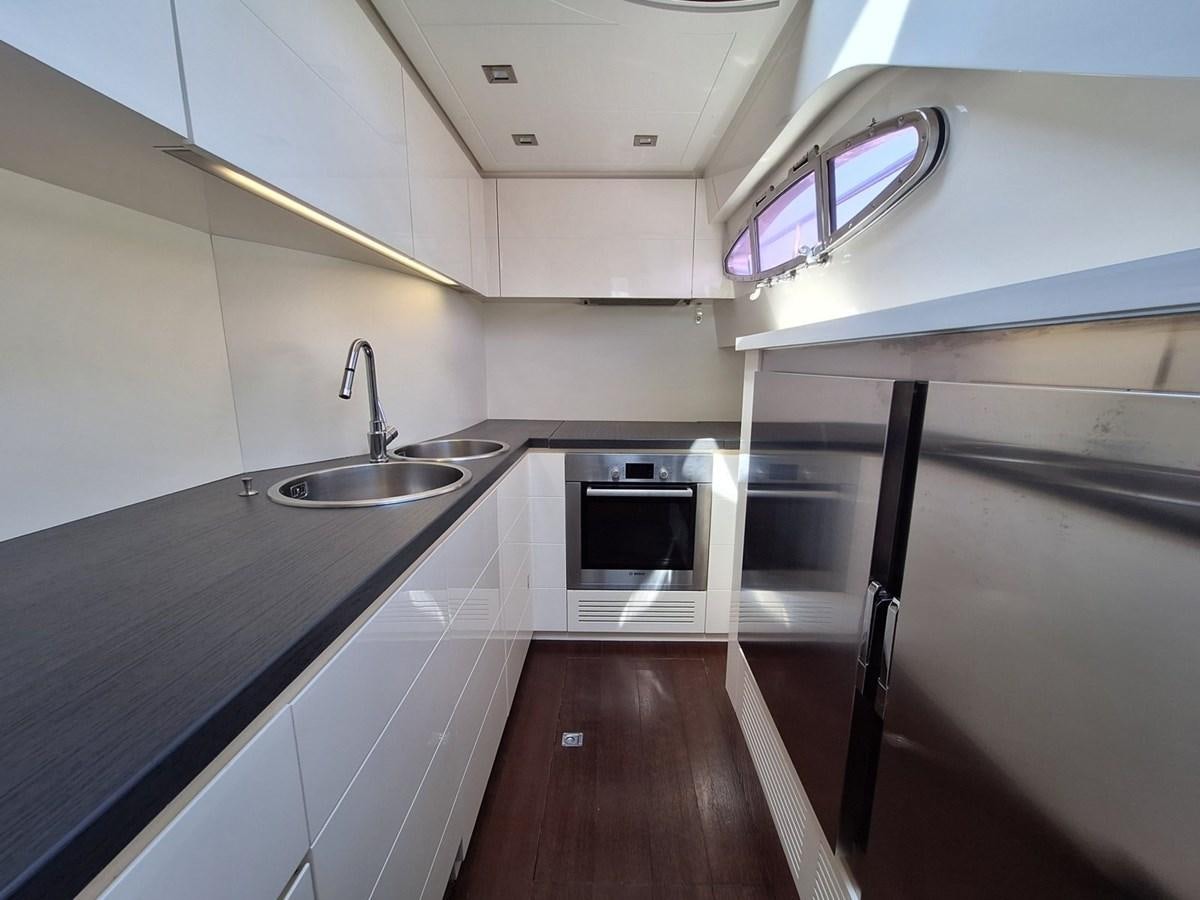 a kitchen with a sink and a stove aboard MYLO Yacht for Sale
