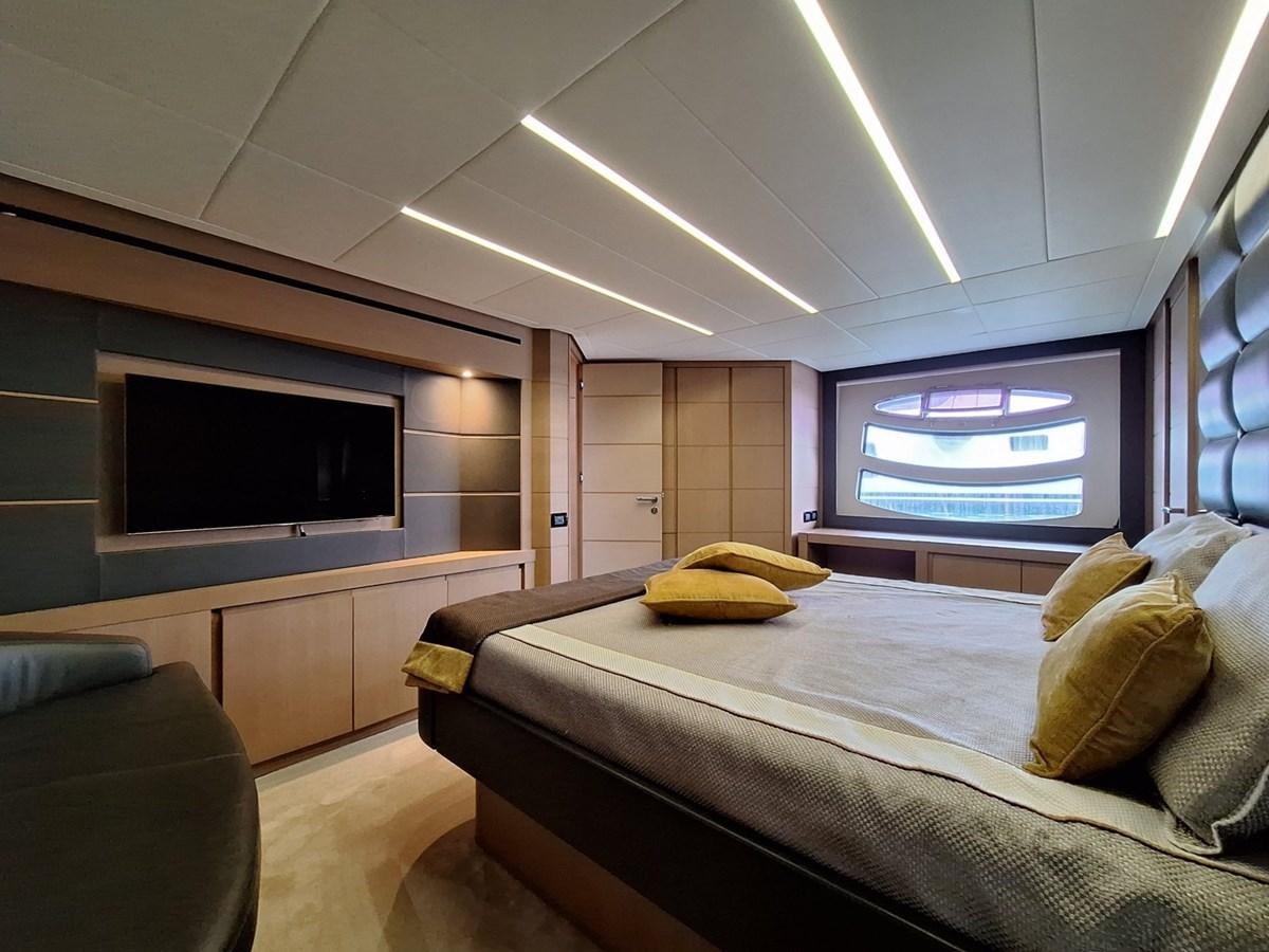 a bedroom with a bed and a tv aboard MYLO Yacht for Sale
