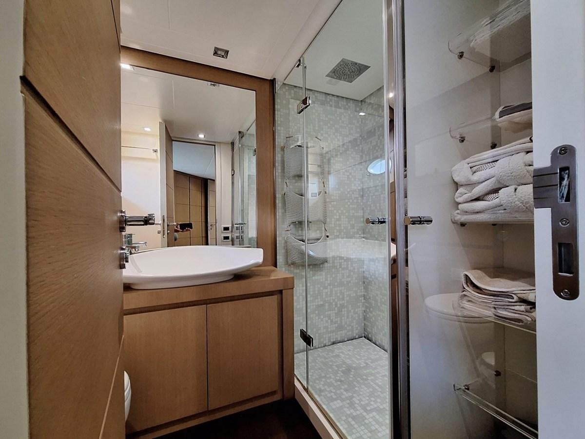 a bathroom with a glass shower aboard MYLO Yacht for Sale