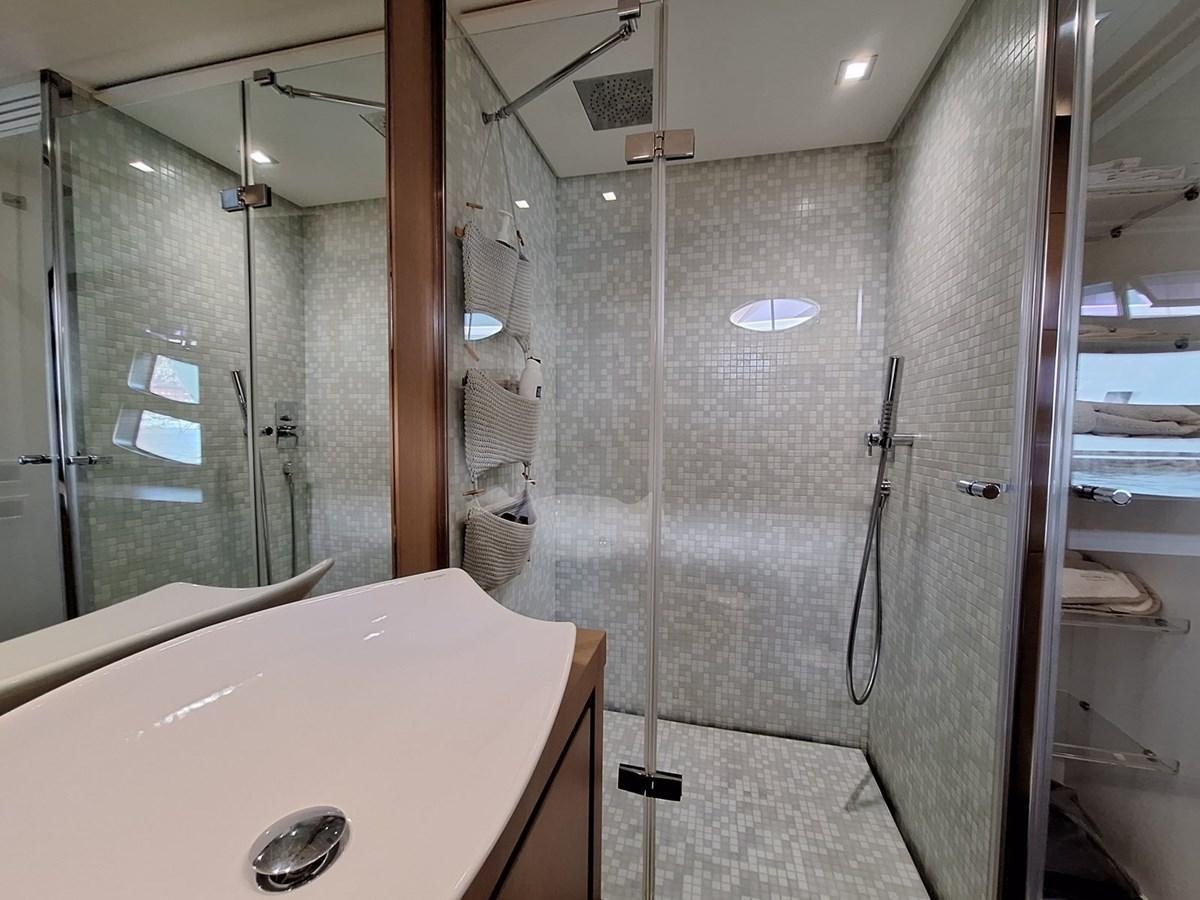 a bathroom with a glass shower aboard MYLO Yacht for Sale