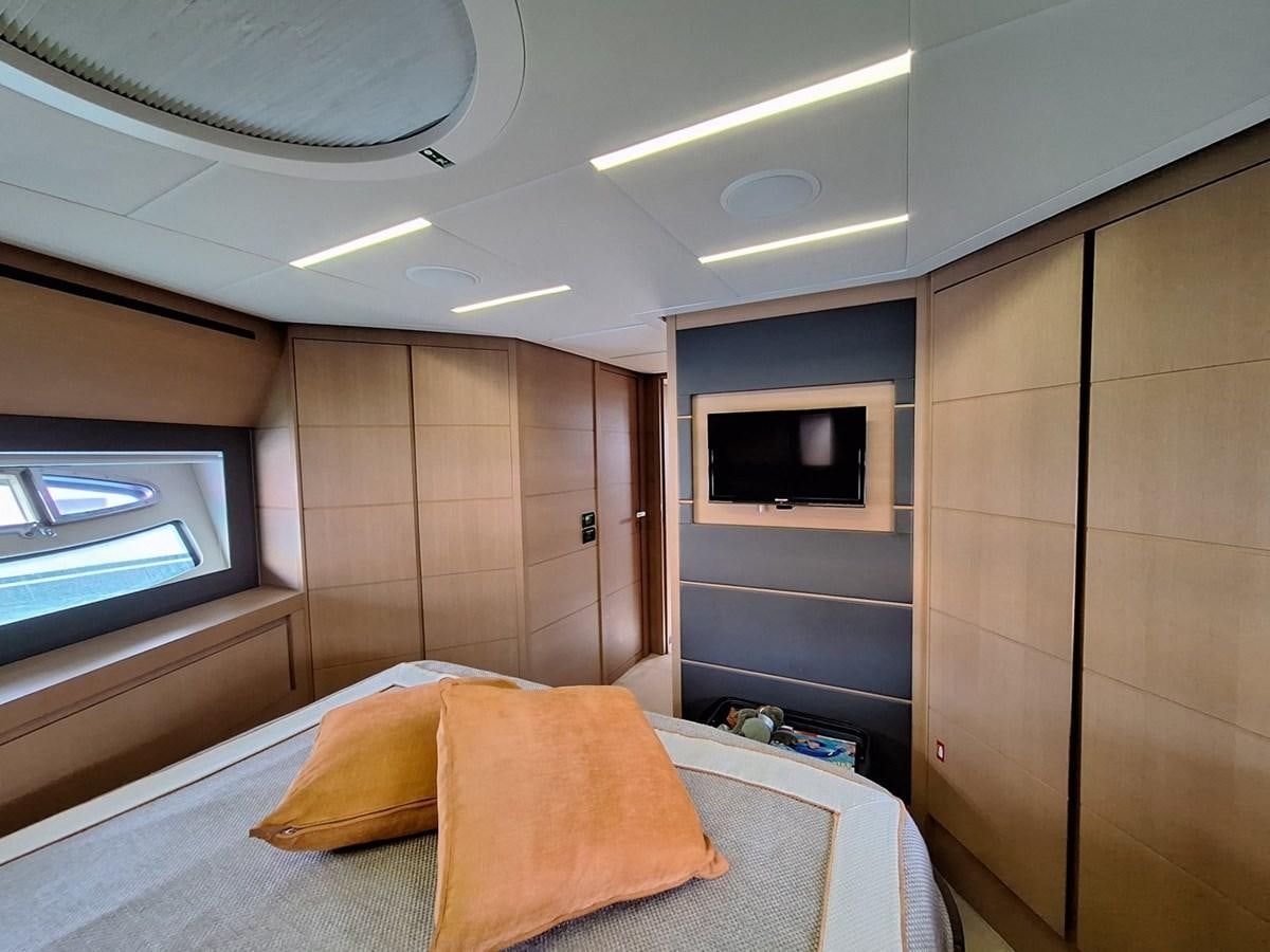 a room with a bed and tv aboard MYLO Yacht for Sale