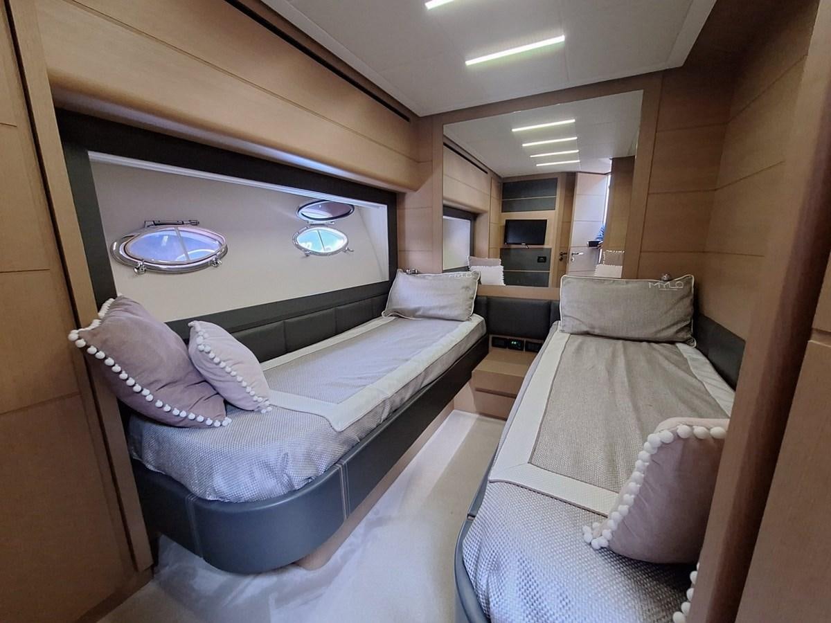 a room with a couch and a television aboard MYLO Yacht for Sale