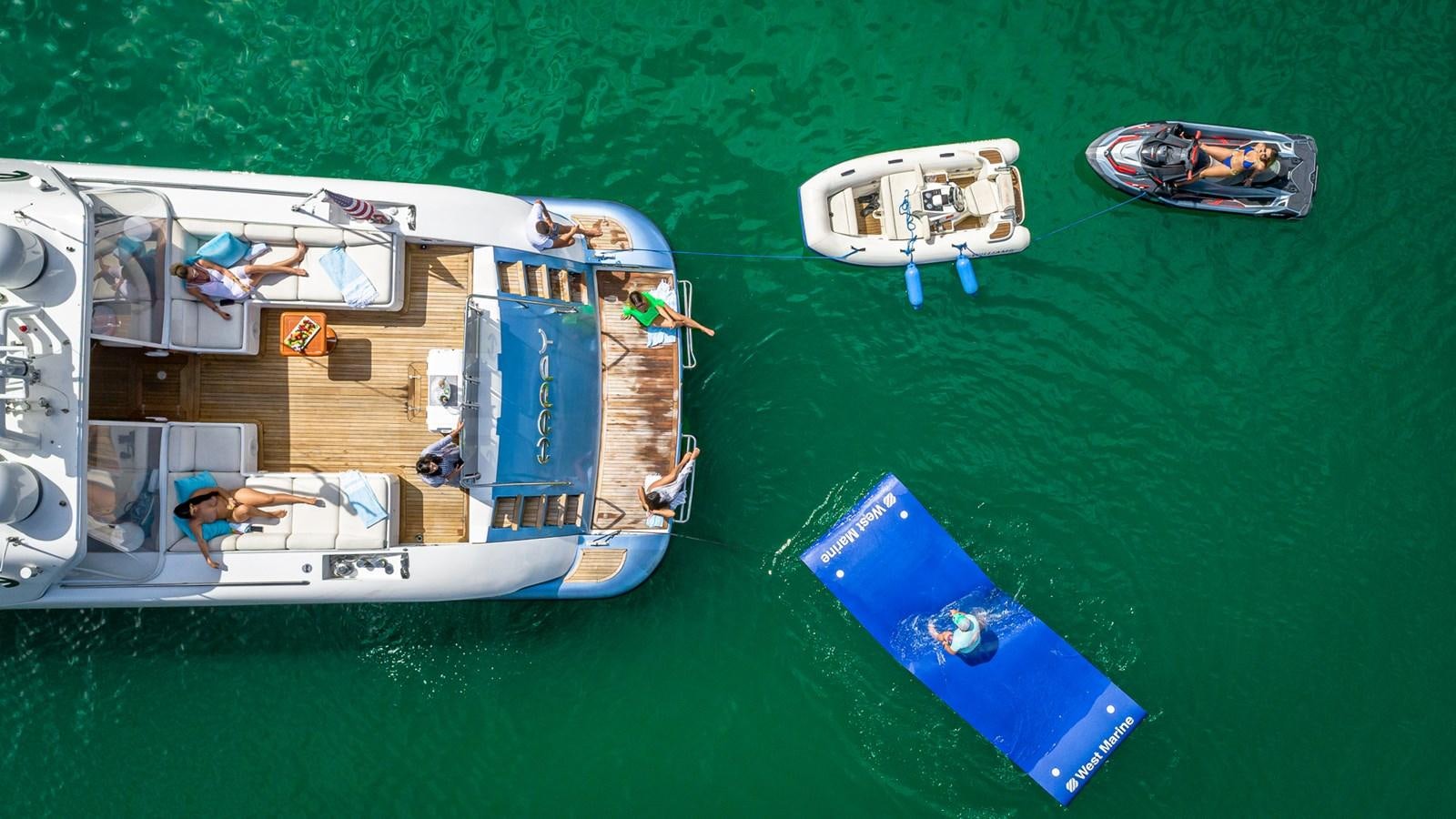 a boat with a dock and a boat on it aboard HAPPY Yacht for Sale